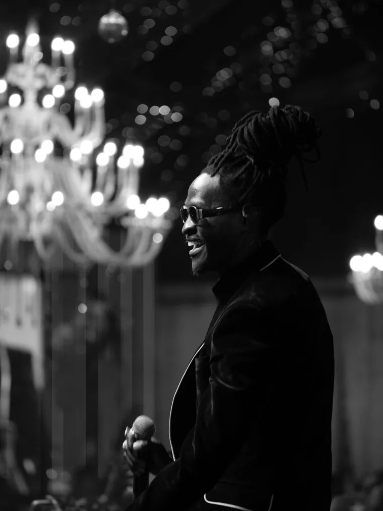 Kodong Klan performer singing in profile, black and white.