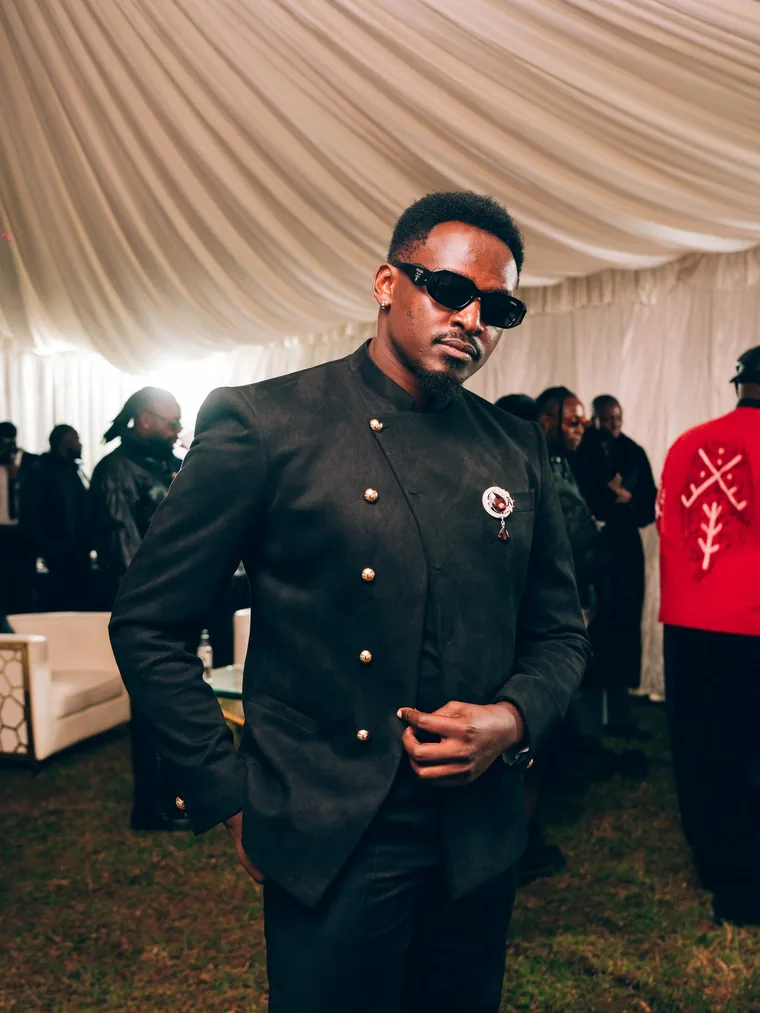 Kodong Klan member in a black gold-button jacket.