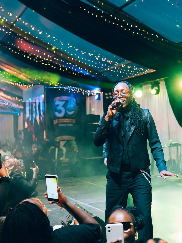 Kodong Klan vocalist performing to a packed front-row crowd.